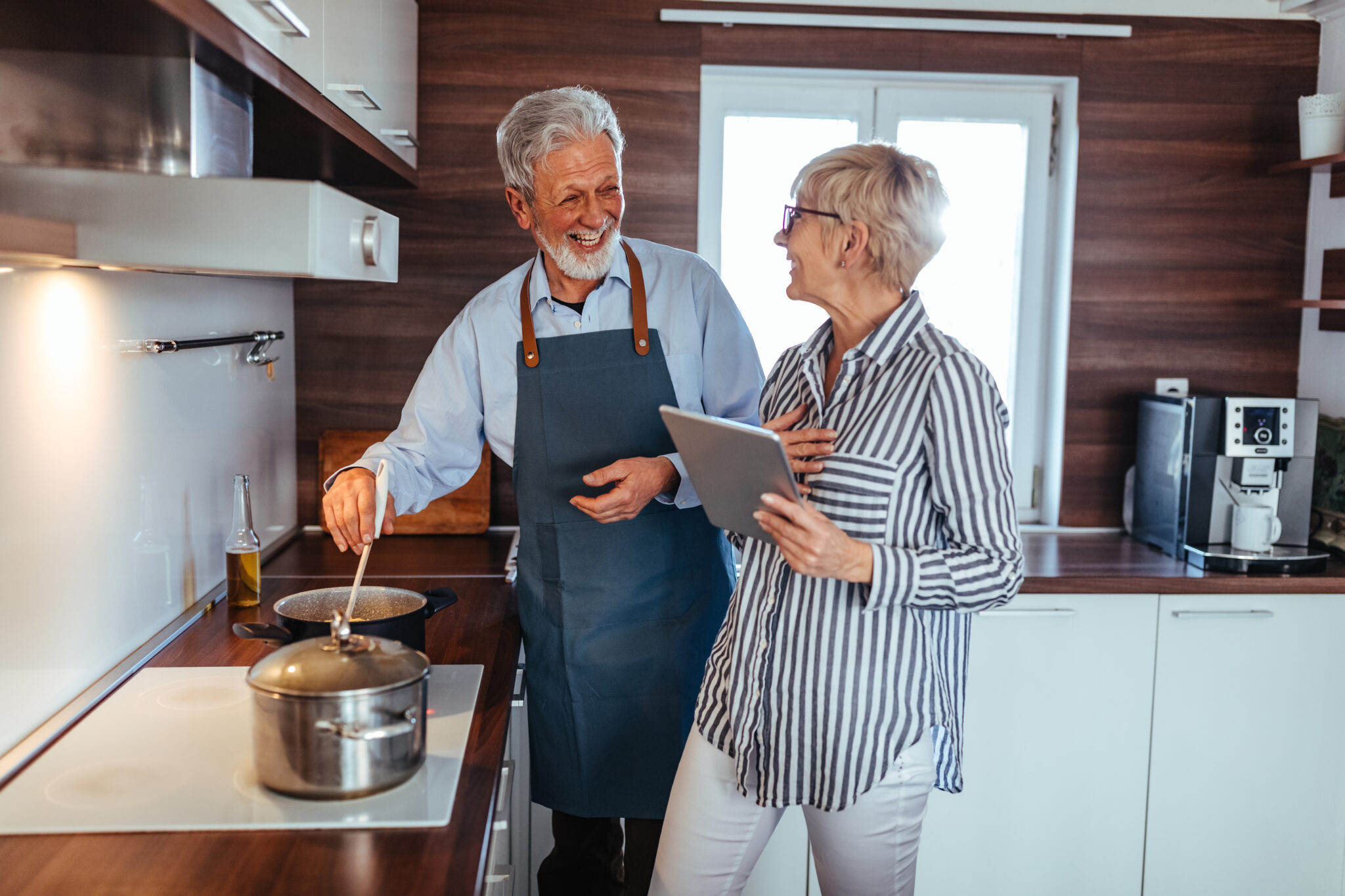 Shot of a senior couple cooking in the kitchen at home